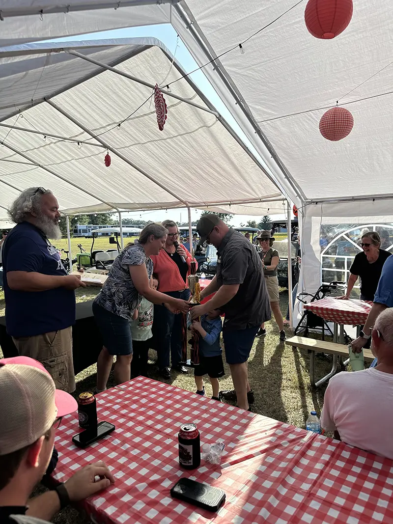 2025 Rolling Smoke BBQ Bash inside the tent handing out awards